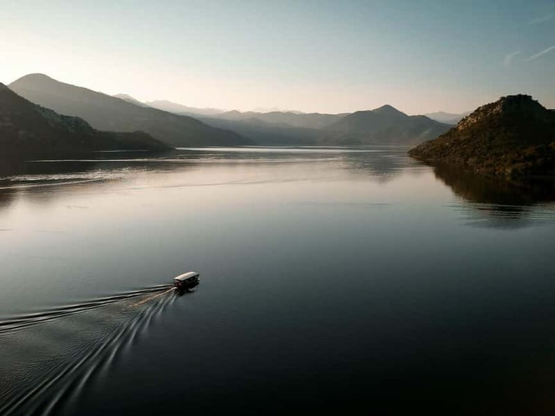 Skadar Lake: Guided Sunset Boat Tour with Wooden Boat & Wine - The short swim: refreshing water, quick clothes planning, and safety gear